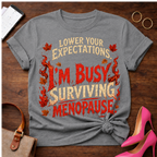 T-Shirt — "Lower Your Expectations. I'm Busy Surviving Menopause" Vintage Quote Tee